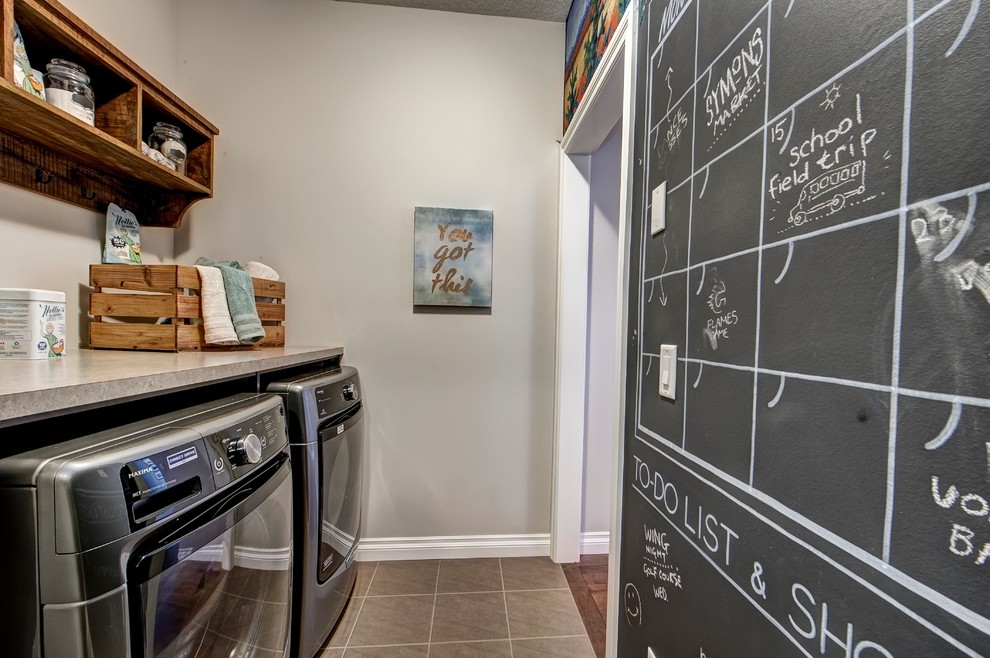 Photo of a small contemporary single-wall dedicated laundry room in Calgary with open cabinets, brown cabinets, laminate benchtops, beige walls, ceramic floors and a side-by-side washer and dryer.