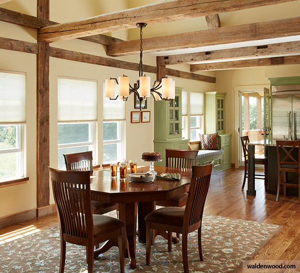 Country dining room in Detroit with black walls, dark hardwood floors, no fireplace and brown floor.