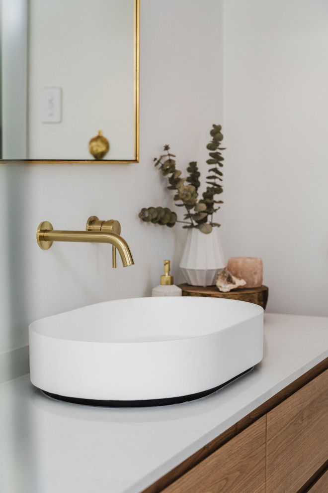 Inspiration for a large mediterranean master bathroom in Perth with medium wood cabinets, a double shower, a one-piece toilet, beige tile, ceramic tile, white walls, ceramic floors, engineered quartz benchtops, an open shower, white benchtops, a niche, a single vanity and a floating vanity.