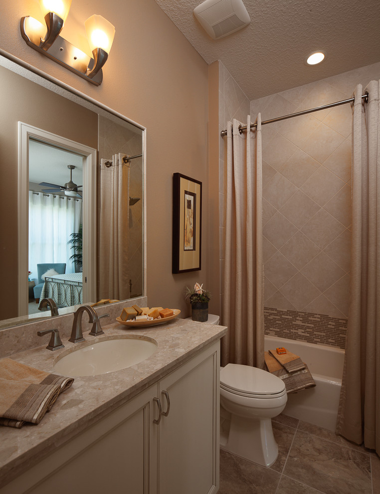 Design ideas for a transitional bathroom in Orlando with raised-panel cabinets, medium wood cabinets, a drop-in tub, a corner shower, beige tile, ceramic tile, beige walls, porcelain floors, a vessel sink, soapstone benchtops, beige floor and an open shower.