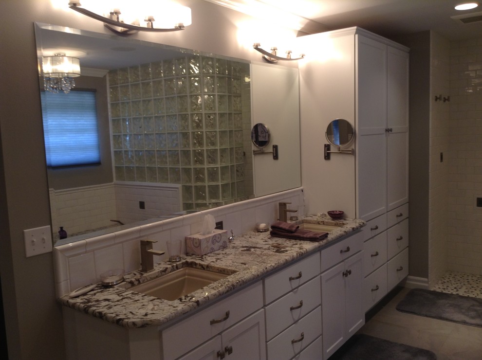 Example of a mid-sized transitional master white tile and subway tile porcelain tile home design design in Seattle with a vessel sink, shaker cabinets, white cabinets, granite countertops, an undermount tub and gray walls