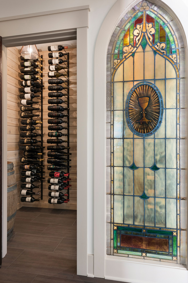 Design ideas for a small transitional wine cellar in Minneapolis with porcelain floors, storage racks and brown floor.