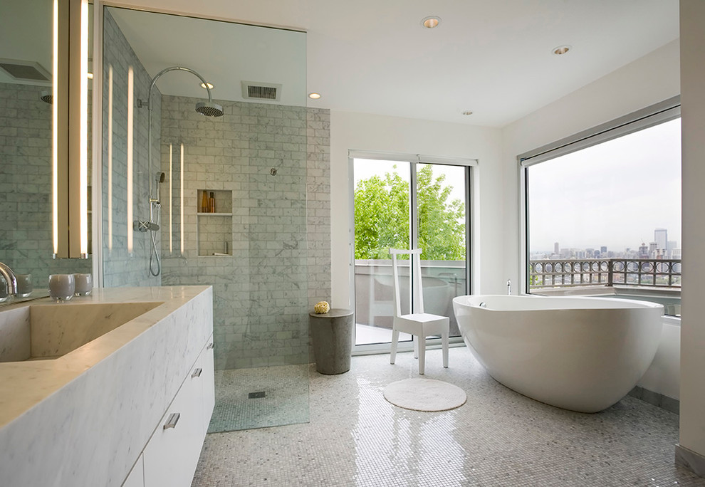 Contemporary bathroom in Seattle with an integrated sink, flat-panel cabinets, white cabinets, a freestanding tub, a corner shower, white tile, mosaic tile and white walls.