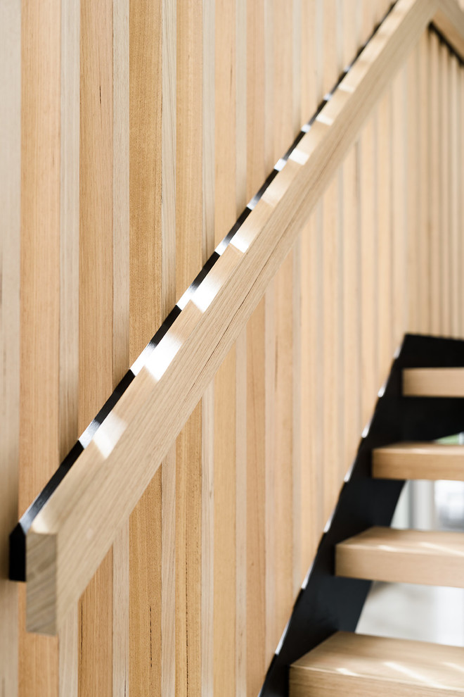 Mid-sized contemporary wood u-shaped staircase in Melbourne with open risers.