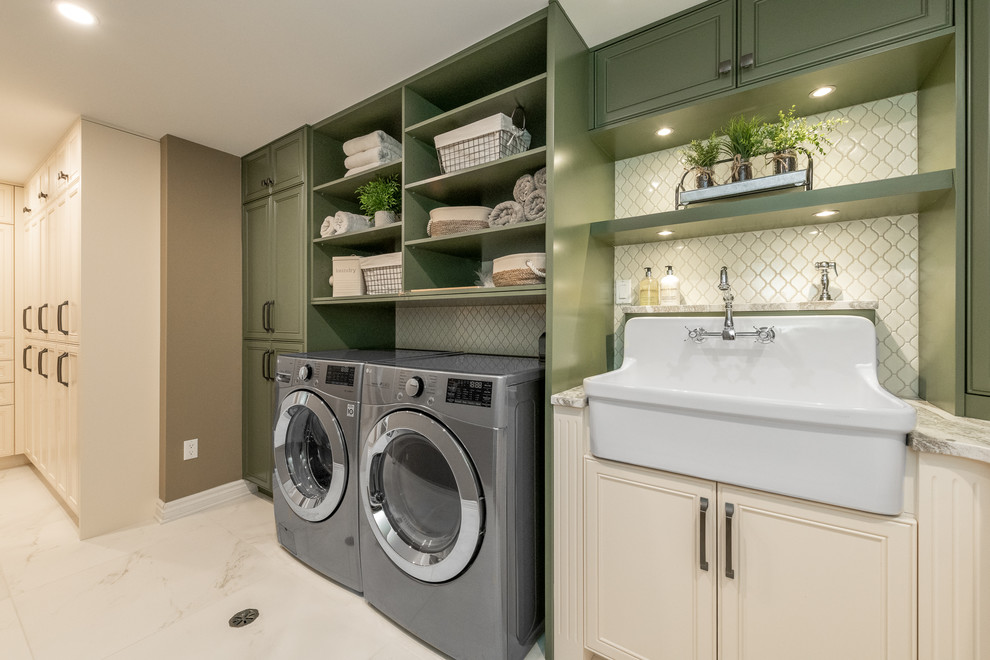 Design ideas for a mid-sized traditional l-shaped dedicated laundry room in Ottawa with a farmhouse sink, beige walls, a side-by-side washer and dryer, beaded inset cabinets, green cabinets, quartz benchtops, porcelain floors, beige floor and multi-coloured benchtop.