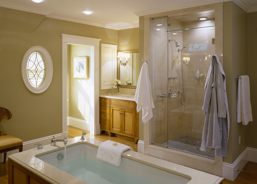 Design ideas for a large traditional master bathroom in Boston with shaker cabinets, light wood cabinets, an undermount tub, an alcove shower, beige tile, brown walls, medium hardwood floors, an undermount sink, brown floor and a hinged shower door.