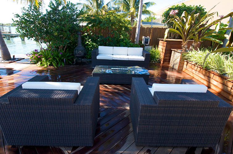 This is an example of a large transitional backyard partial sun formal garden for summer in Miami with concrete pavers.