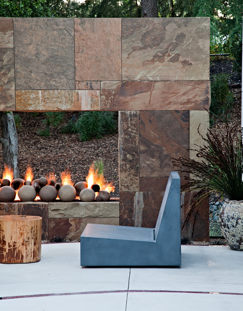 Large contemporary backyard patio in San Francisco with a fire feature, concrete slab and no cover.