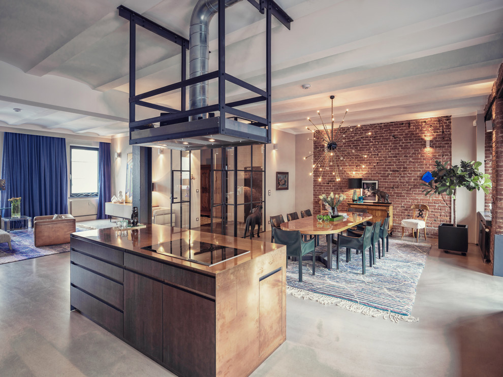 Photo of an expansive industrial open plan dining in Nuremberg with white walls, concrete floors and grey floor.