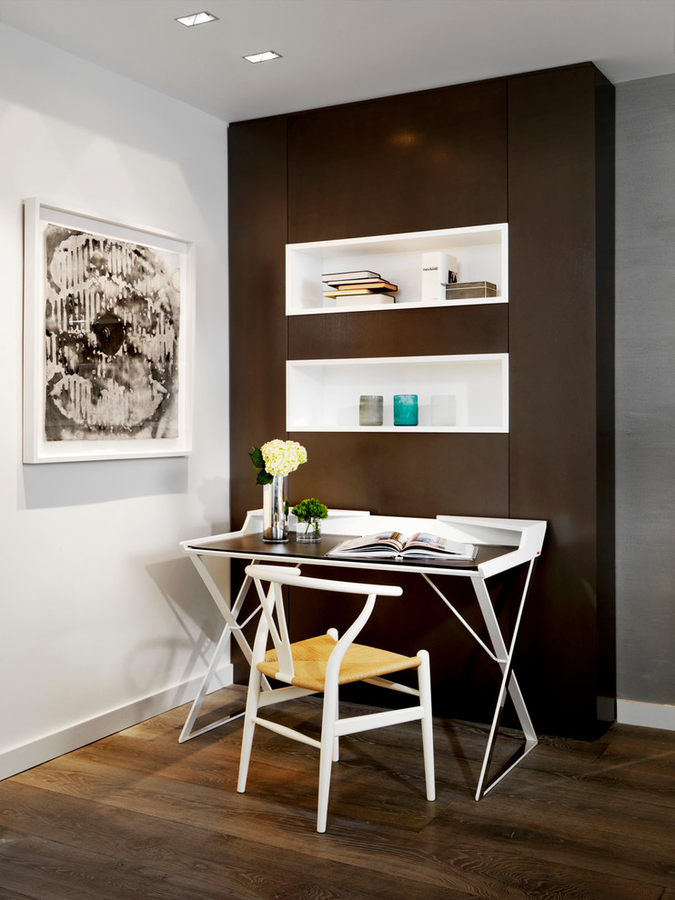 This is an example of a contemporary study room in Miami with a freestanding desk, brown walls and dark hardwood floors.
