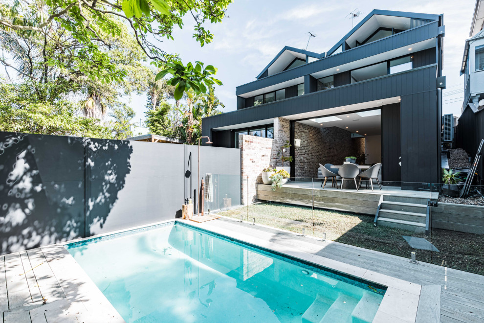 Inspiration for a small contemporary backyard rectangular pool in Sydney with decking.