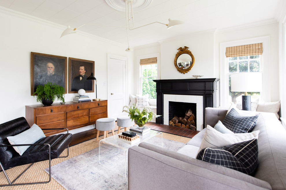 Mid-sized transitional living room in Seattle with white walls, dark hardwood floors, a standard fireplace, a brick fireplace surround and brown floor.