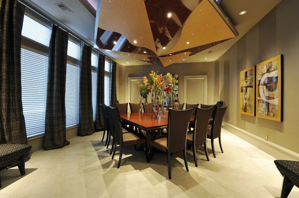 Contemporary separate dining room in Houston with beige walls.