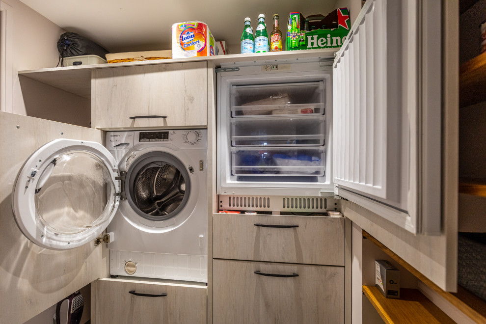Small modern l-shaped dedicated laundry room in Other with an integrated washer and dryer.