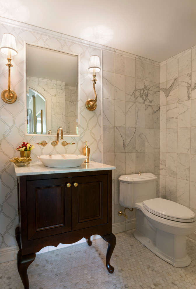 Photo of a small traditional powder room in Boston with a vessel sink, furniture-like cabinets, dark wood cabinets, marble benchtops, a one-piece toilet, white tile, stone tile, white walls and marble floors.