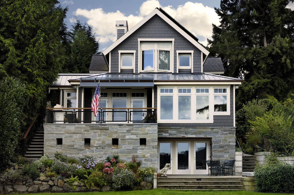 This is an example of a traditional exterior in Seattle with wood siding.