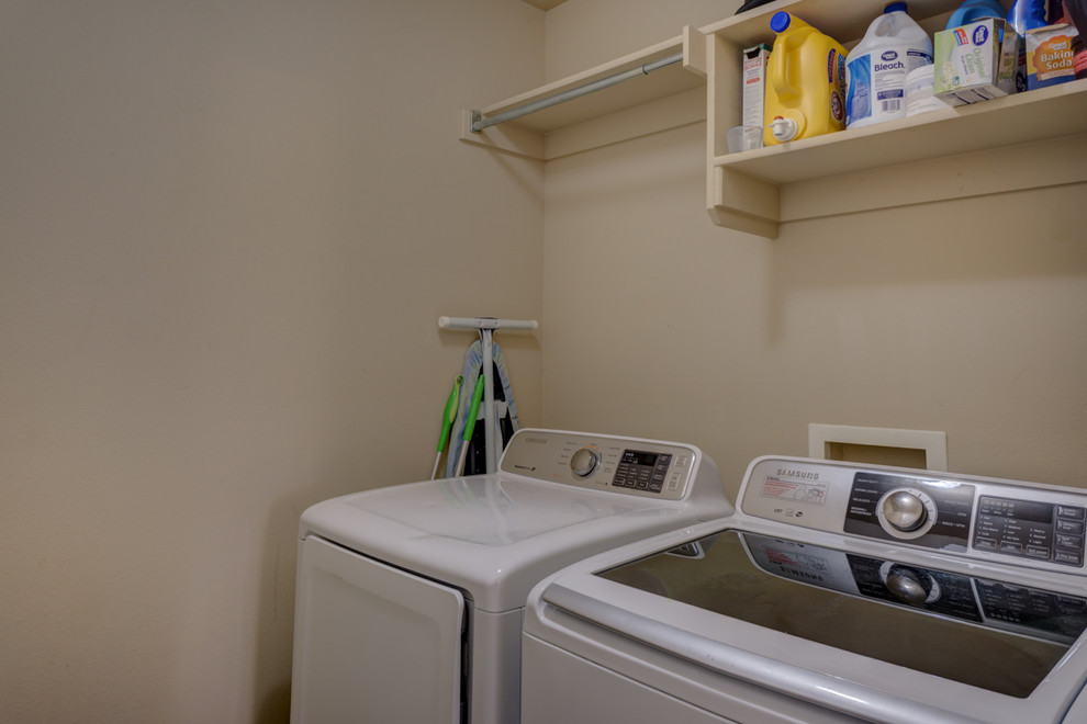 Design ideas for a small traditional single-wall dedicated laundry room in Austin with open cabinets, beige cabinets, beige walls and a side-by-side washer and dryer.