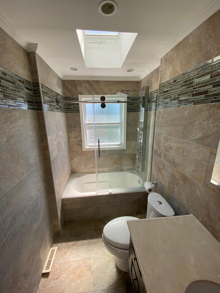 Photo of a medium sized modern ensuite bathroom in New York with shaker cabinets, dark wood cabinets, an alcove bath, a shower/bath combination, a two-piece toilet, multi-coloured tiles, stone tiles, multi-coloured walls, slate flooring, a submerged sink, quartz worktops, beige floors, a sliding door, white worktops, a single sink and a built in vanity unit.