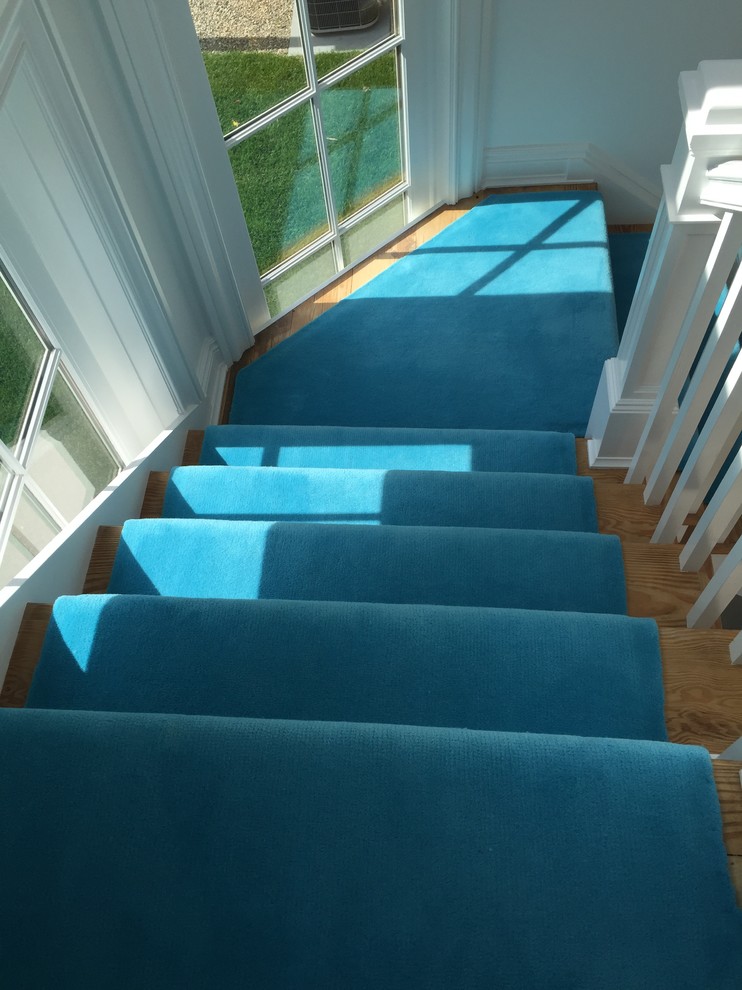 This is an example of a medium sized contemporary carpeted l-shaped staircase in Melbourne with carpeted risers.