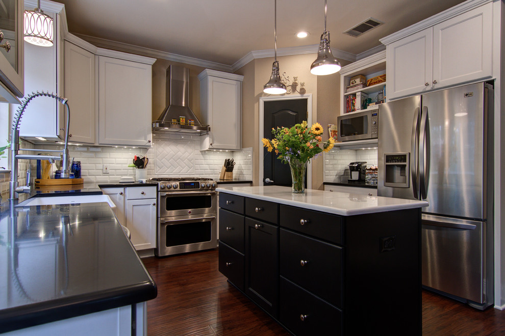 Inspiration for a transitional u-shaped eat-in kitchen remodel in Austin with a farmhouse sink, recessed-panel cabinets, white cabinets, quartz countertops, white backsplash, subway tile backsplash and stainless steel appliances
