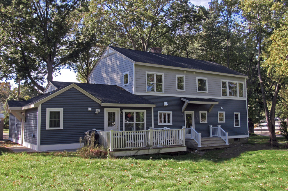 Photo of a mid-sized traditional two-storey blue house exterior in Boston with mixed siding, a gable roof and a shingle roof.