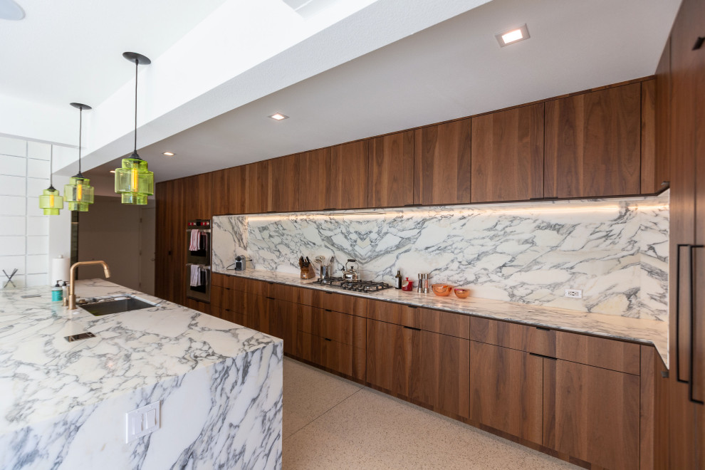 Inspiration for a large midcentury single-wall eat-in kitchen in Other with an undermount sink, flat-panel cabinets, dark wood cabinets, quartz benchtops, white splashback, engineered quartz splashback, panelled appliances, terrazzo floors, a peninsula, white floor, white benchtop and exposed beam.
