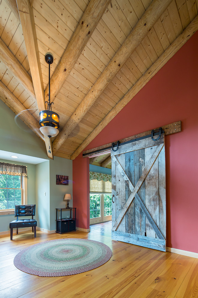 Photo of a country loft-style family room in Burlington with a library and medium hardwood floors.