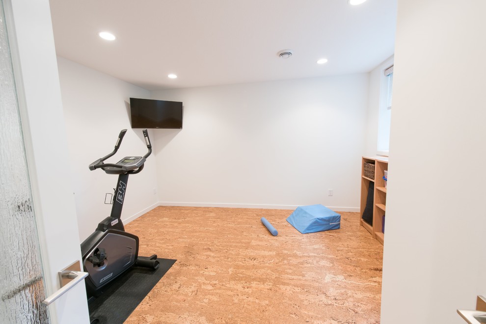 This is an example of a mid-sized contemporary home yoga studio in Minneapolis with white walls and cork floors.