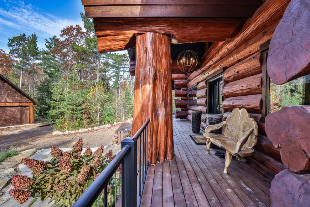 Mid-sized mountain style brown three-story wood and board and batten gable roof photo with a shingle roof and a brown roof