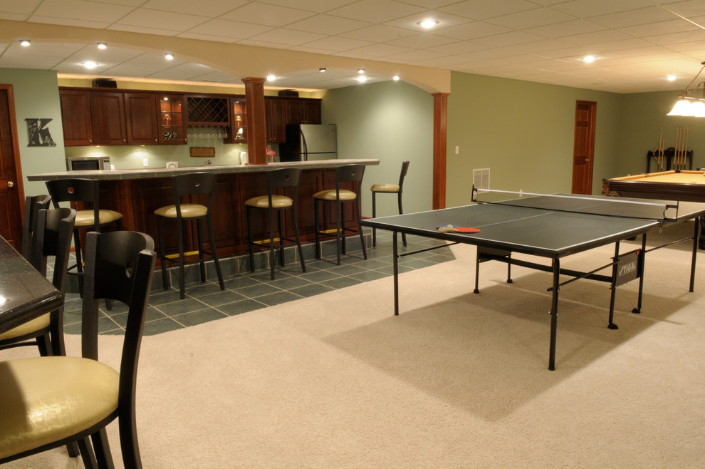 Example of a large transitional underground carpeted and beige floor basement design with green walls and no fireplace