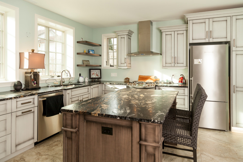 Open concept kitchen - mid-sized transitional l-shaped beige floor open concept kitchen idea in Toronto with an undermount sink, shaker cabinets, white cabinets, marble countertops, stainless steel appliances and an island