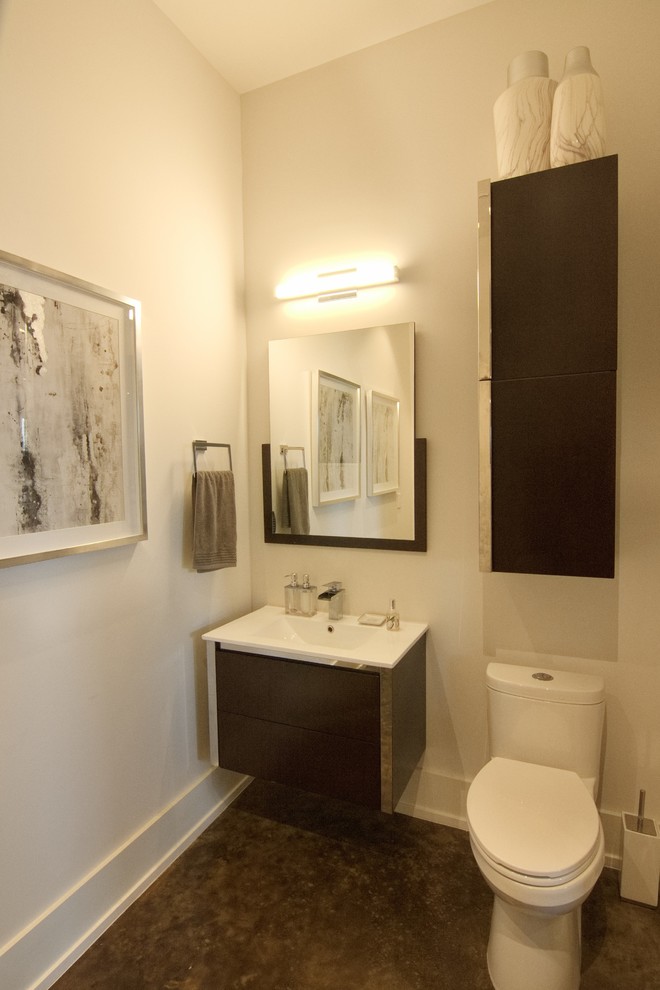 Inspiration for a large modern powder room in Houston with flat-panel cabinets, a two-piece toilet, white walls, concrete floors, an integrated sink, brown floor, white benchtops and white cabinets.