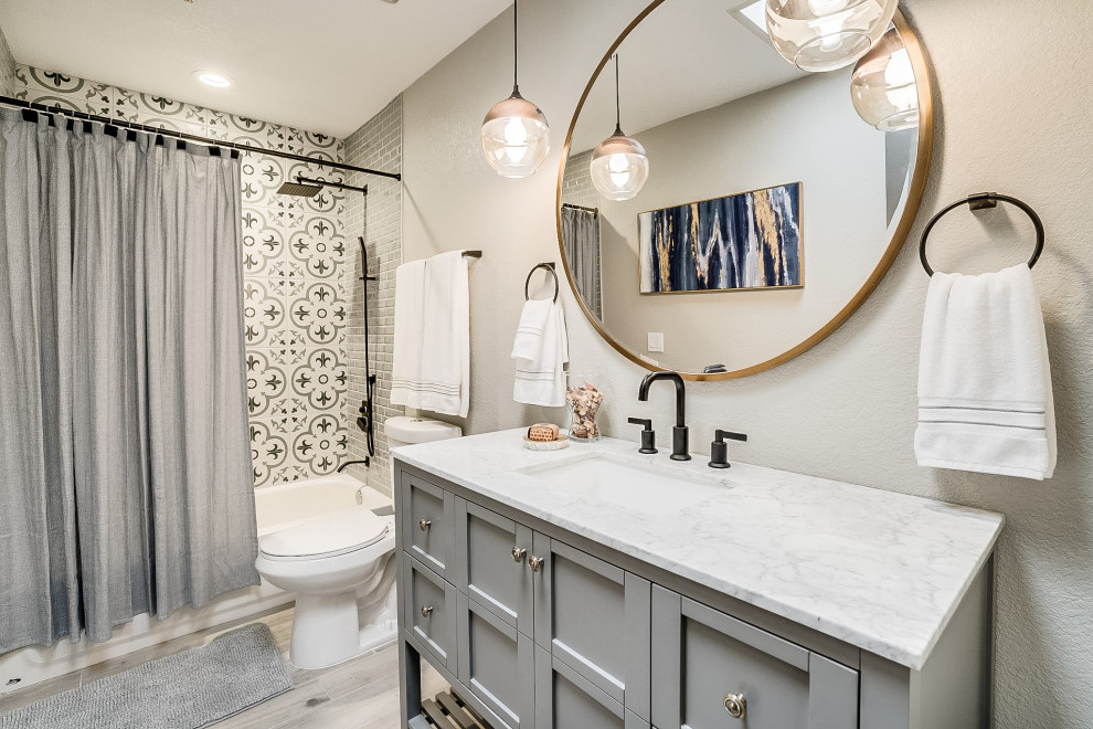 Photo of a transitional bathroom in Phoenix with shaker cabinets, grey cabinets, an alcove tub, a shower/bathtub combo, grey walls, wood-look tile, an undermount sink, grey floor, a shower curtain, white benchtops, a single vanity and a freestanding vanity.