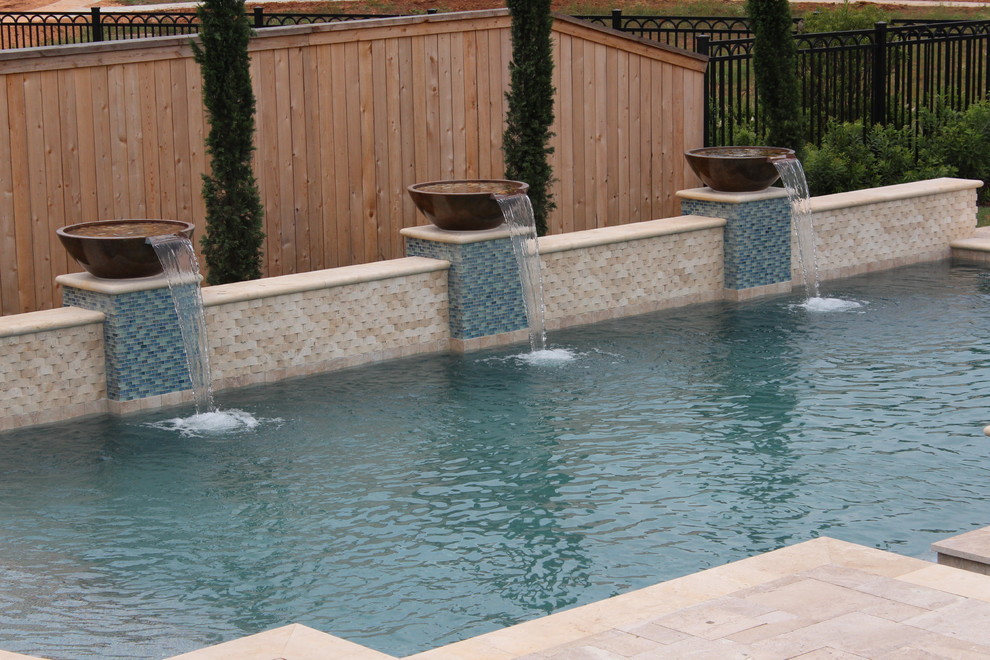 Example of a large transitional backyard stone and rectangular hot tub design in Houston