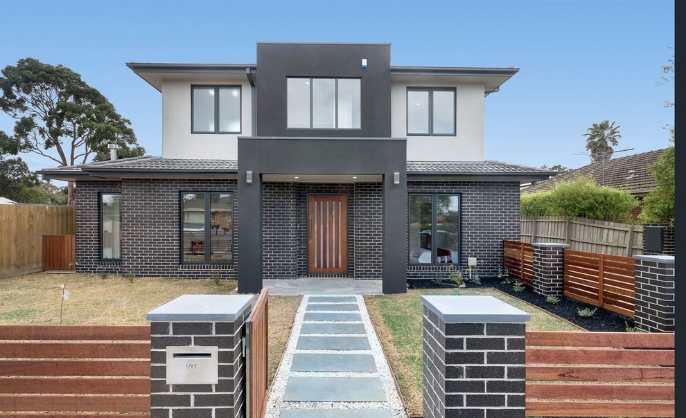 Large modern two-storey brick brown townhouse exterior in Melbourne with a tile roof.