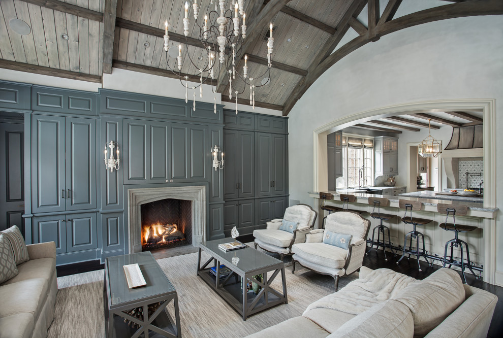 Mid-sized traditional open concept living room in Houston with grey walls, dark hardwood floors, a standard fireplace, a stone fireplace surround, a concealed tv and black floor.