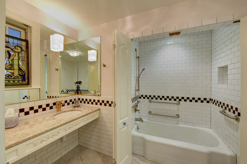 This is an example of a large traditional master bathroom in Jacksonville with an alcove tub, a shower/bathtub combo, white tile, subway tile, white walls, an undermount sink, granite benchtops and beige floor.