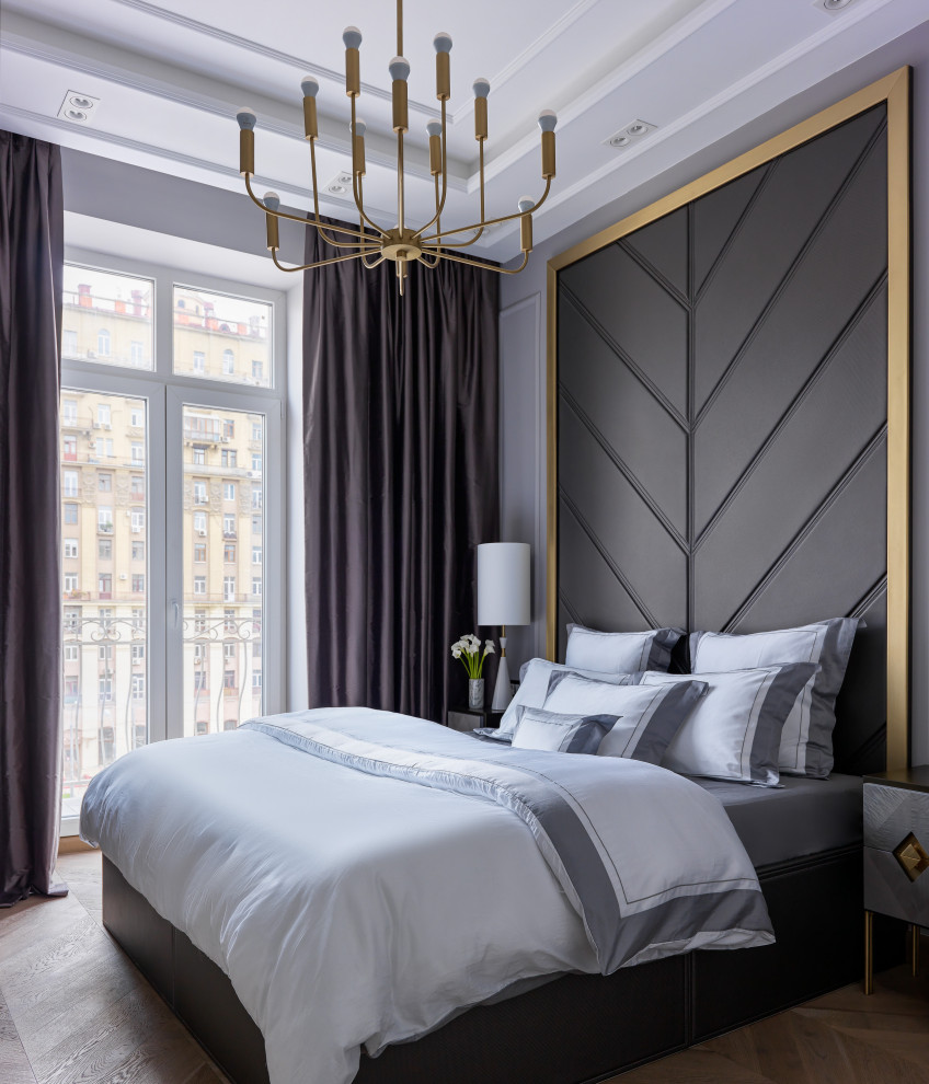 Inspiration for a mid-sized transitional master bedroom in Moscow with light hardwood floors, grey walls, brown floor, recessed and panelled walls.