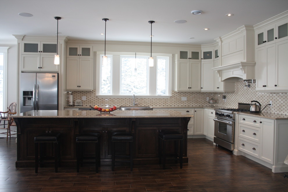 Large elegant l-shaped medium tone wood floor eat-in kitchen photo with an island, recessed-panel cabinets, yellow cabinets, quartz countertops, black backsplash, cement tile backsplash, stainless steel appliances and a farmhouse sink