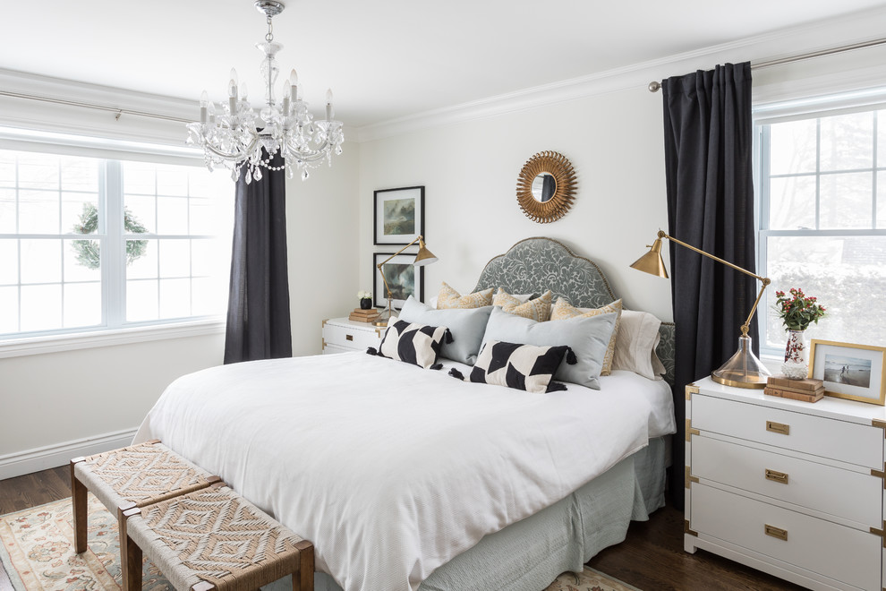 This is an example of a traditional master bedroom in Montreal with white walls and dark hardwood floors.