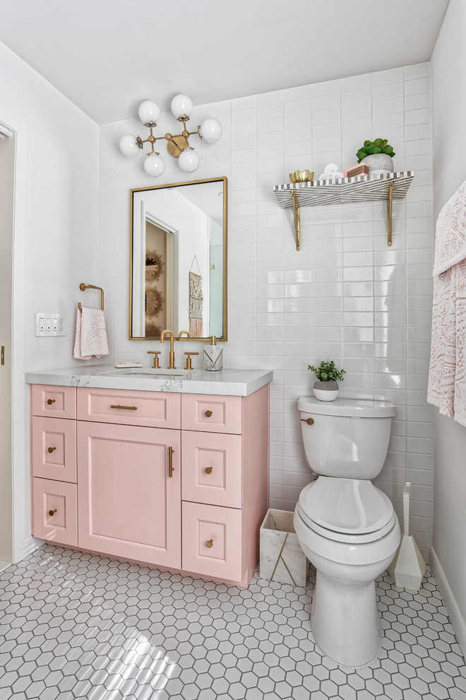 Design ideas for a mid-sized transitional master bathroom in New York with a two-piece toilet, white tile, subway tile, white walls, mosaic tile floors, white floor, white benchtops, recessed-panel cabinets and an undermount sink.