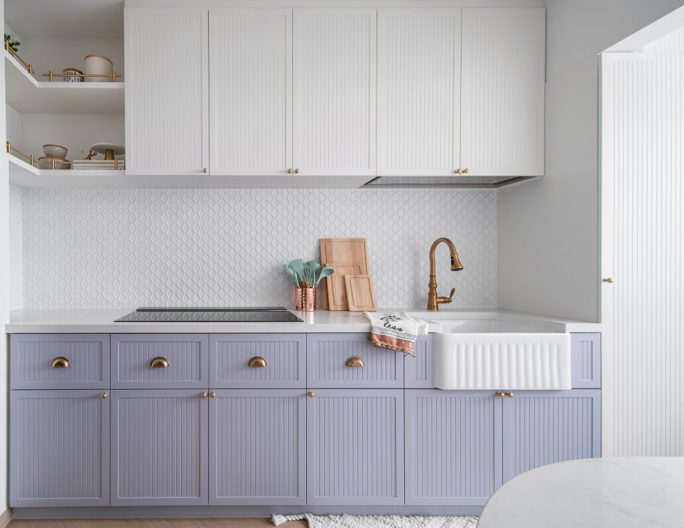 This is an example of a scandinavian single-wall kitchen in Singapore with a farmhouse sink, recessed-panel cabinets, purple cabinets, white splashback, mosaic tile splashback, medium hardwood floors, brown floor and white benchtop.