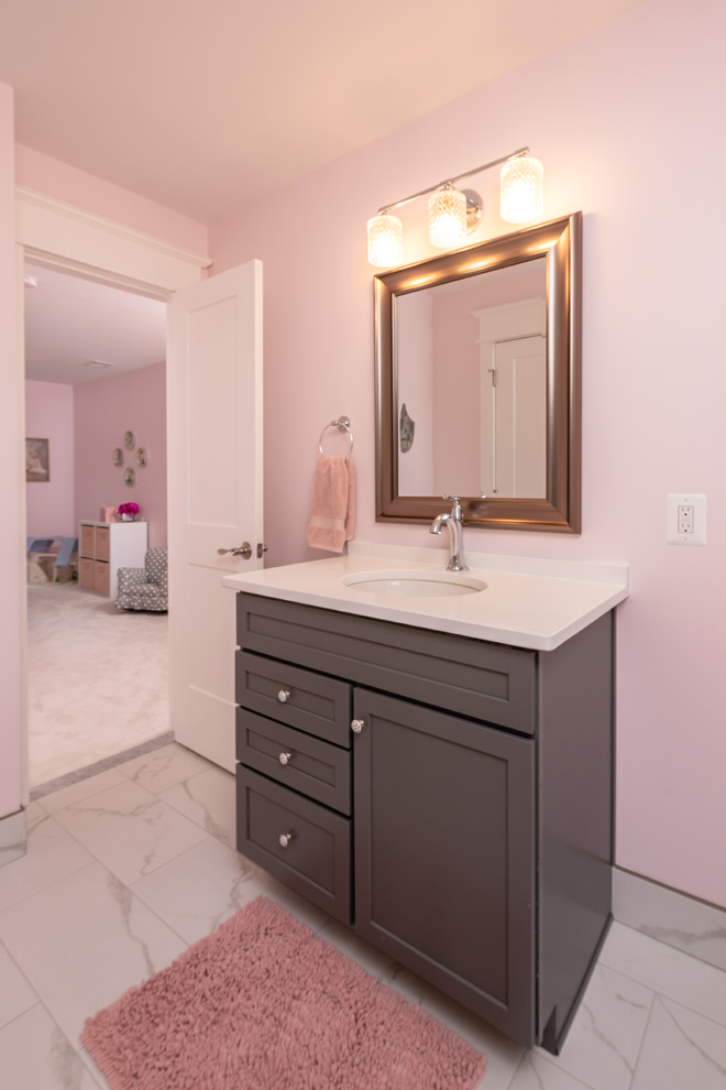 Inspiration for a mid-sized transitional kids bathroom in DC Metro with shaker cabinets, grey cabinets, a two-piece toilet, white tile, pink walls, an undermount sink, white benchtops, porcelain floors, engineered quartz benchtops and white floor.