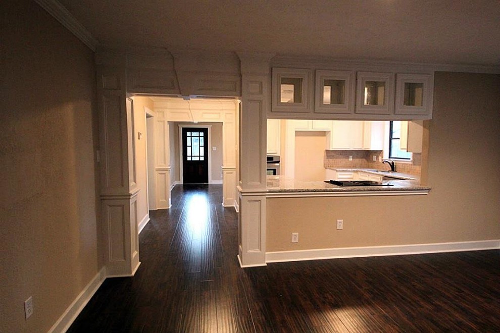 Mid-sized transitional u-shaped ceramic tile and beige floor enclosed kitchen photo in Houston with a double-bowl sink, recessed-panel cabinets, white cabinets, granite countertops, beige backsplash, ceramic backsplash, stainless steel appliances and a peninsula