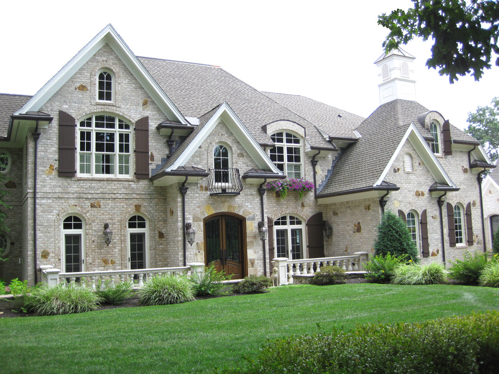 Inspiration for a huge craftsman beige two-story mixed siding gable roof remodel in Boston with a tile roof