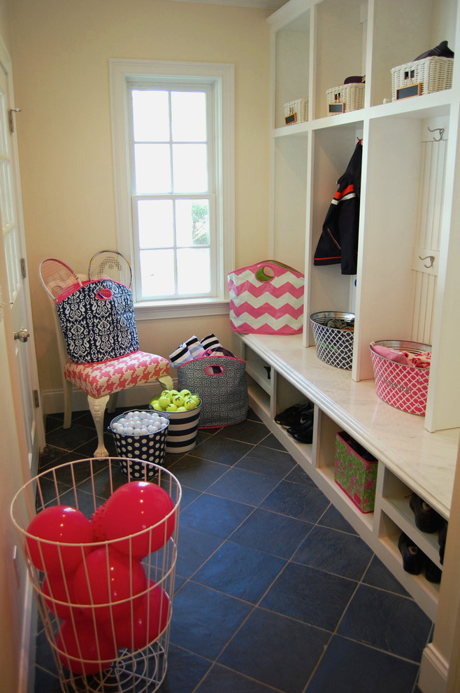 Design ideas for a small traditional mudroom in Boston with yellow walls and ceramic floors.