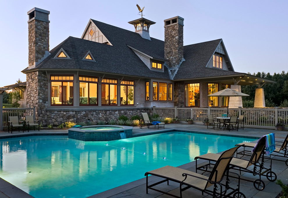 Inspiration for a large arts and crafts backyard custom-shaped pool in Boston with a hot tub and tile.