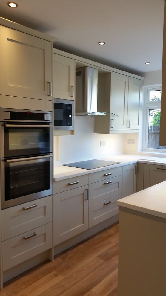 Design ideas for a medium sized contemporary u-shaped kitchen/diner in Kent with shaker cabinets and white splashback.