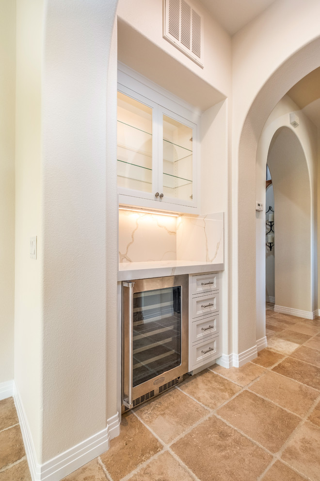 Inspiration for a mid-sized transitional porcelain tile and beige floor hallway remodel in Orange County with beige walls