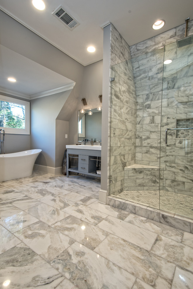 This is an example of a small contemporary master bathroom in Omaha with open cabinets, grey cabinets, a freestanding tub, an open shower, gray tile, grey walls, marble floors, an integrated sink, solid surface benchtops and marble.